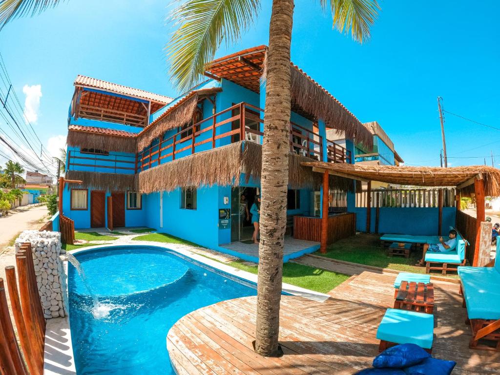 a villa with a swimming pool and a house at Casa Nui in Porto De Galinhas