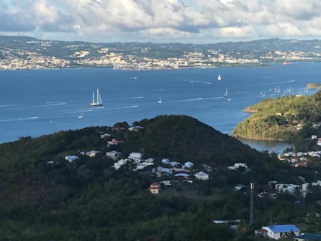 a view of a large body of water with boats at BAY VIEW MARTINIQUE in Les Anses-dʼArlets