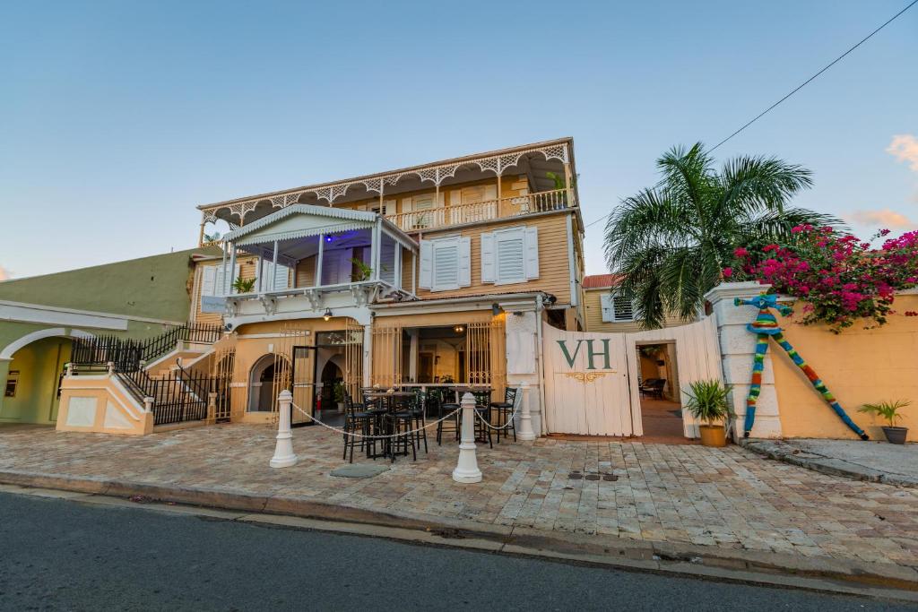 a house on a street with a vii sign in front of it at Victoria House in Frederiksted