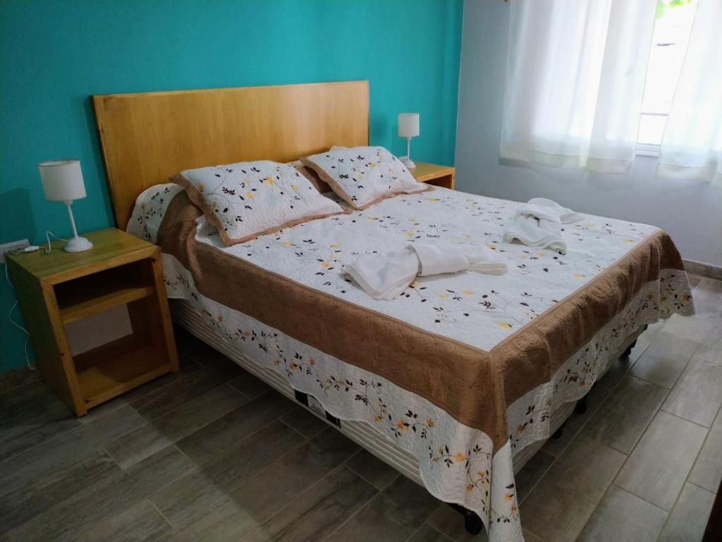 a bedroom with a bed with two towels on it at La Casa de la Oma in Tandil