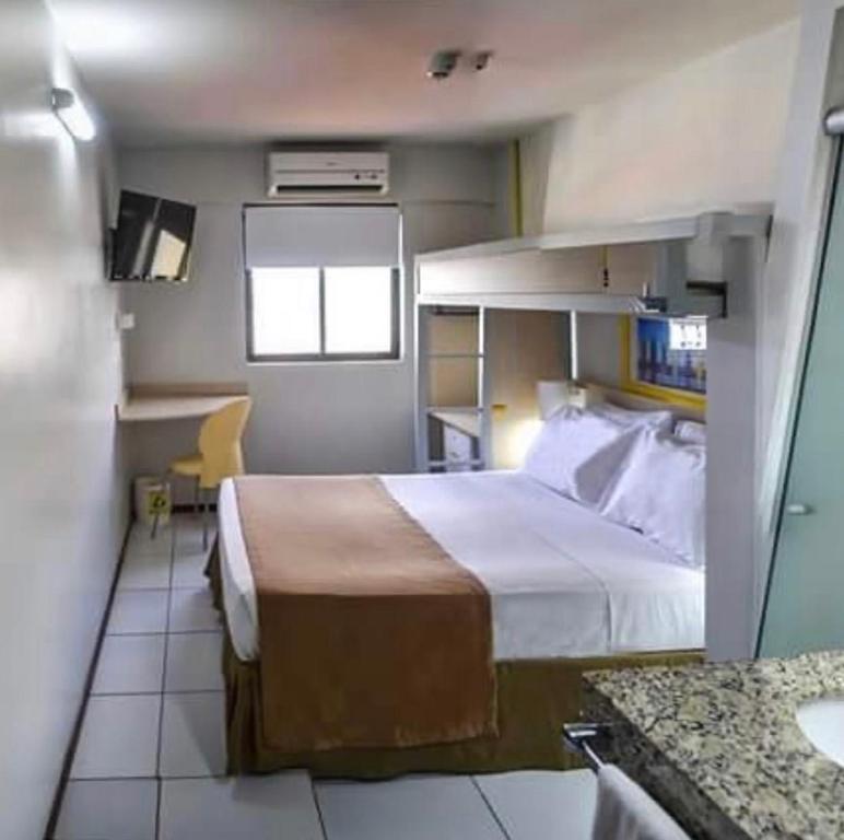 a hotel room with a bed and a bathroom at Expresso R1 Hotel Economy Suites in Maceió