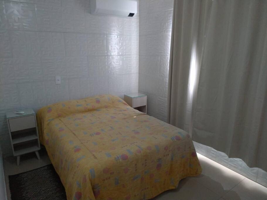 Giường trong phòng chung tại Casa agradável em Camboriú com estacionamento no pátio