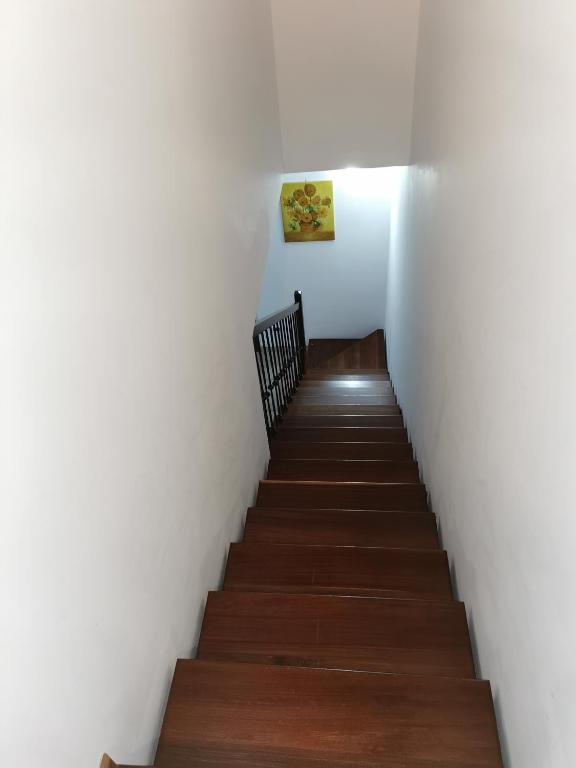 Partanna的住宿－Ciappella，铺有木地板的白色墙壁楼梯