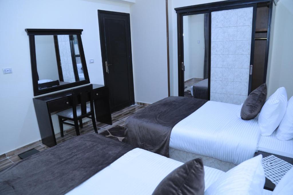 A bed or beds in a room at Jewel Fayed Hotel