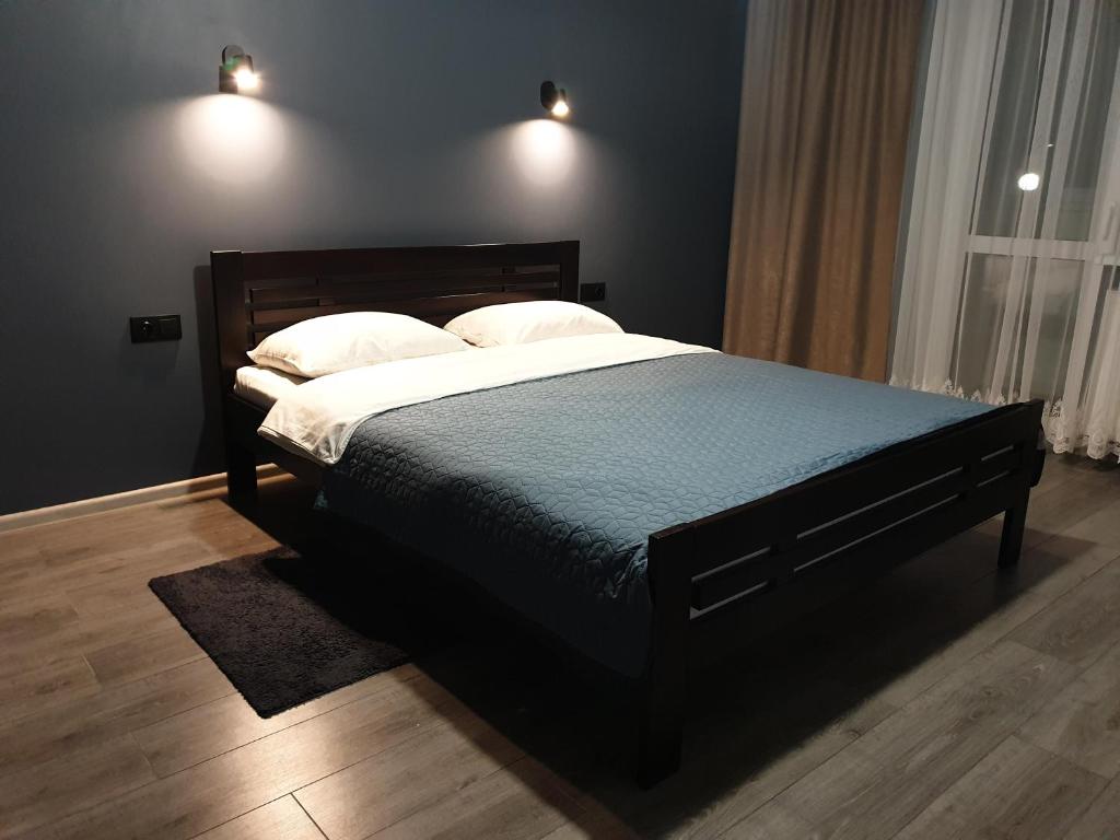 1 dormitorio con 1 cama grande y 2 almohadas en Premium apartments 2, en Leópolis