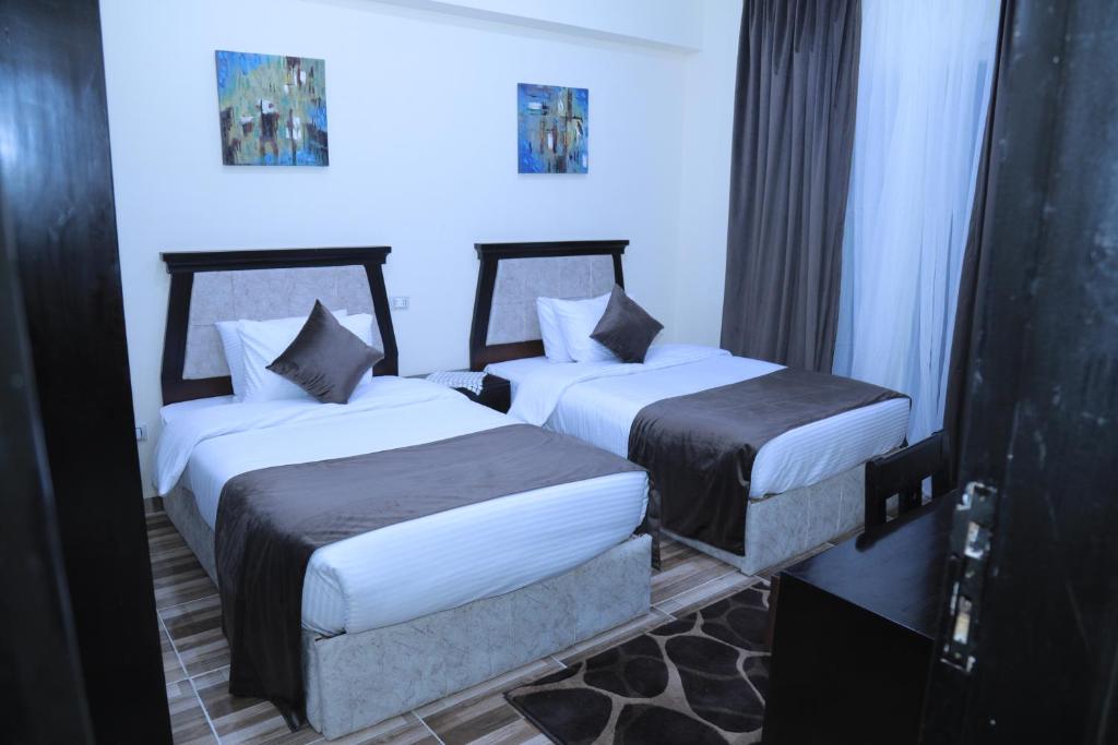 A bed or beds in a room at Jewel Fayed Hotel