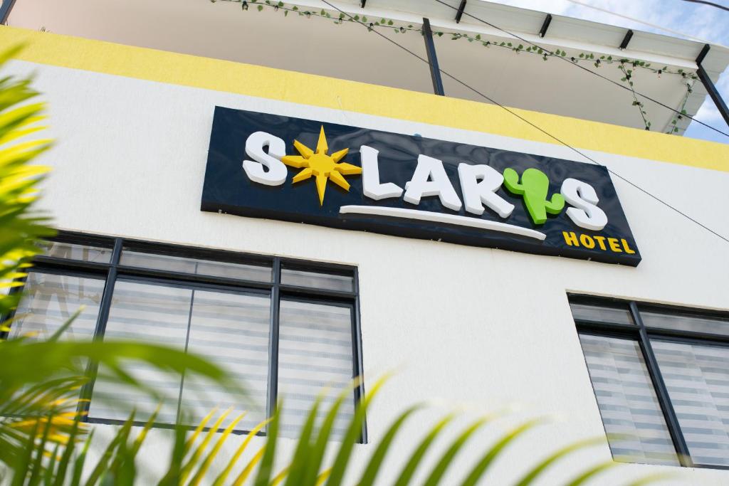 a sign for a laax motel on the side of a building at Solaris Hotel in Villavieja