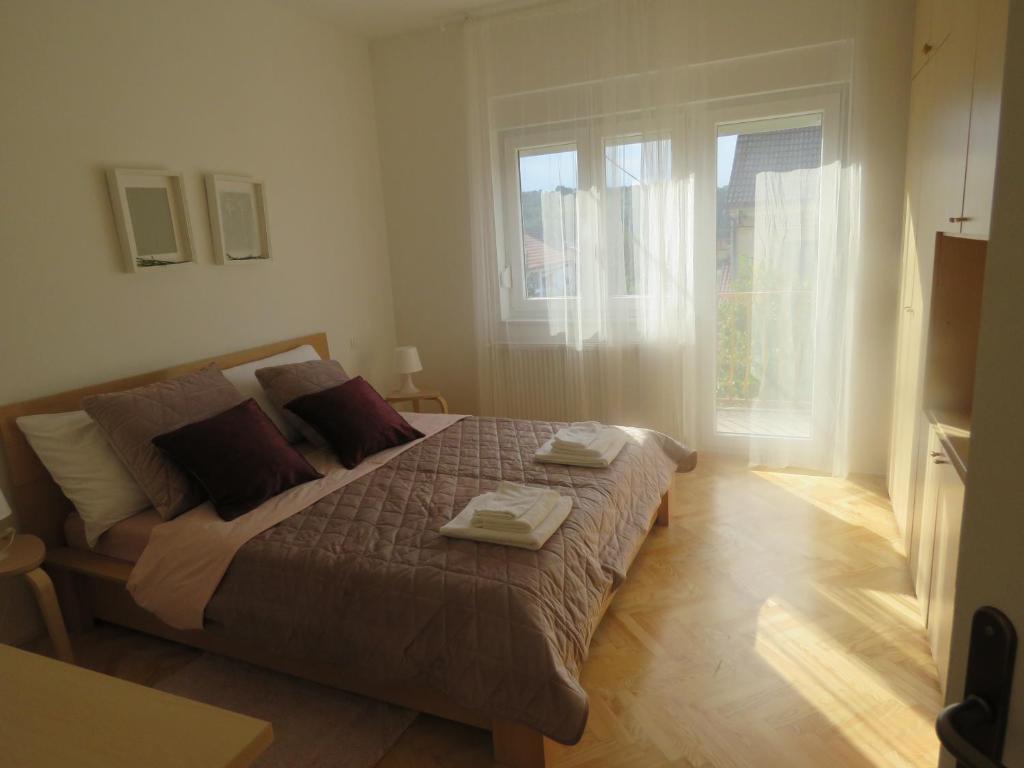 1 dormitorio con 1 cama con 2 toallas en Sani Apartments, en Začretje