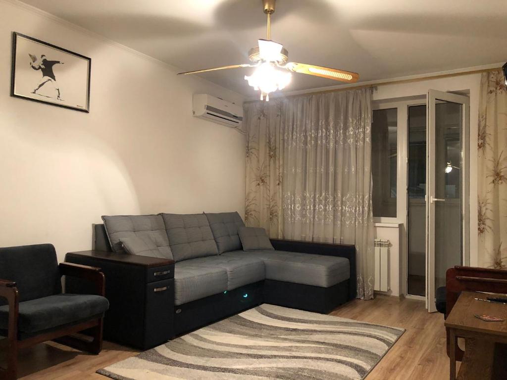 a living room with a couch and a chair at Clean apartment on Lunacharskogo street in Tiraspol