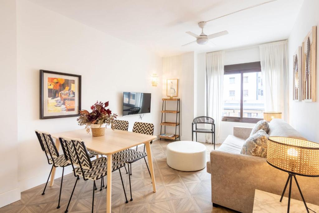 a living room with a table and a couch at Salado Triana Suites by Valcambre in Seville