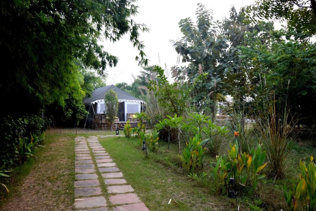 a path leading to a gazebo in a garden at Sultan Bagh Resort by The Sky Imperial in Sawāi Mādhopur