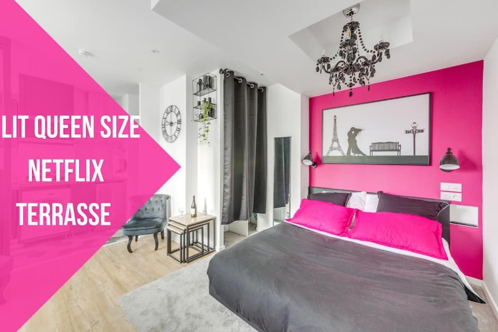 Dormitorio rosa con cama grande con almohadas rosas en Studio le petit baroque en Chevilly-Larue