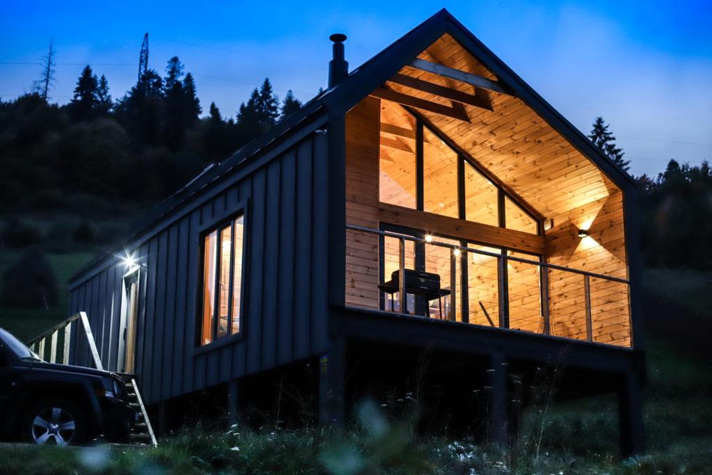 a tiny house sitting on top of a field at GUKHOUSE in Huklyvyy