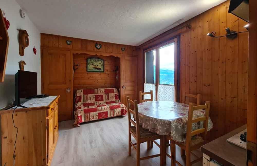a dining room with a table and a bedroom at Alpenrose Saint Gervais les Bains in Saint-Gervais-les-Bains