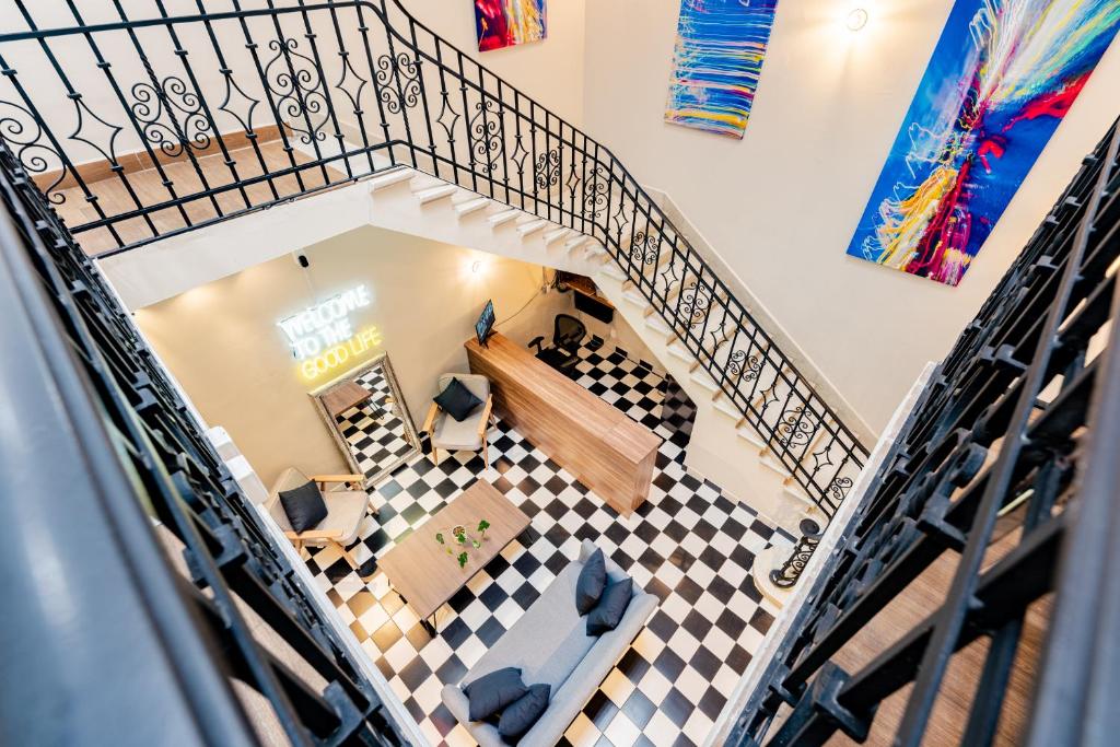 an overhead view of a living room with a spiral staircase at Casa Danubio near Reforma by VH in Mexico City