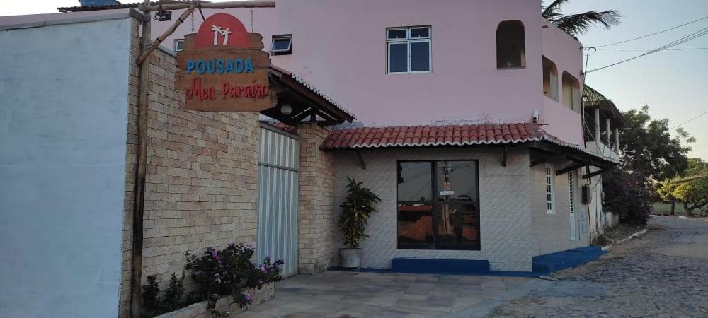 a building with a sign on the side of it at Pousada Meu Paraíso in Lagoinha