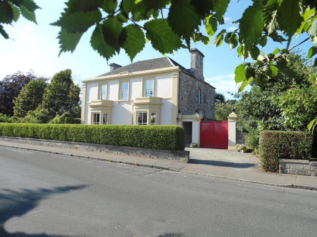 a white house on the side of a street at Garvally House Guest House in Alloa