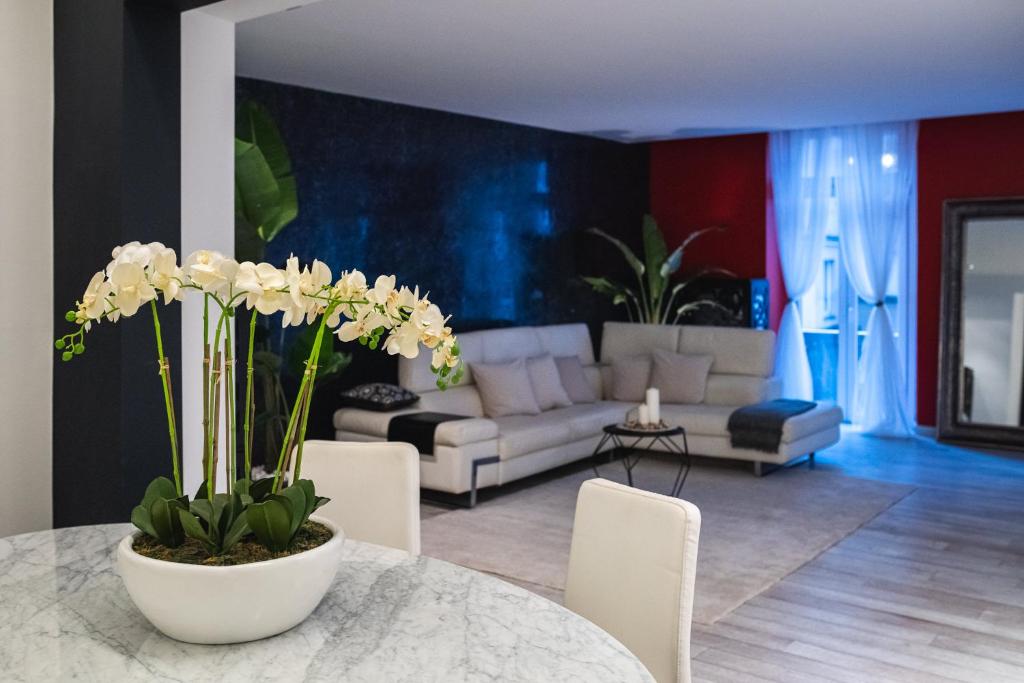 a living room with a white couch and a table at V APARTMENTS in Bellinzona