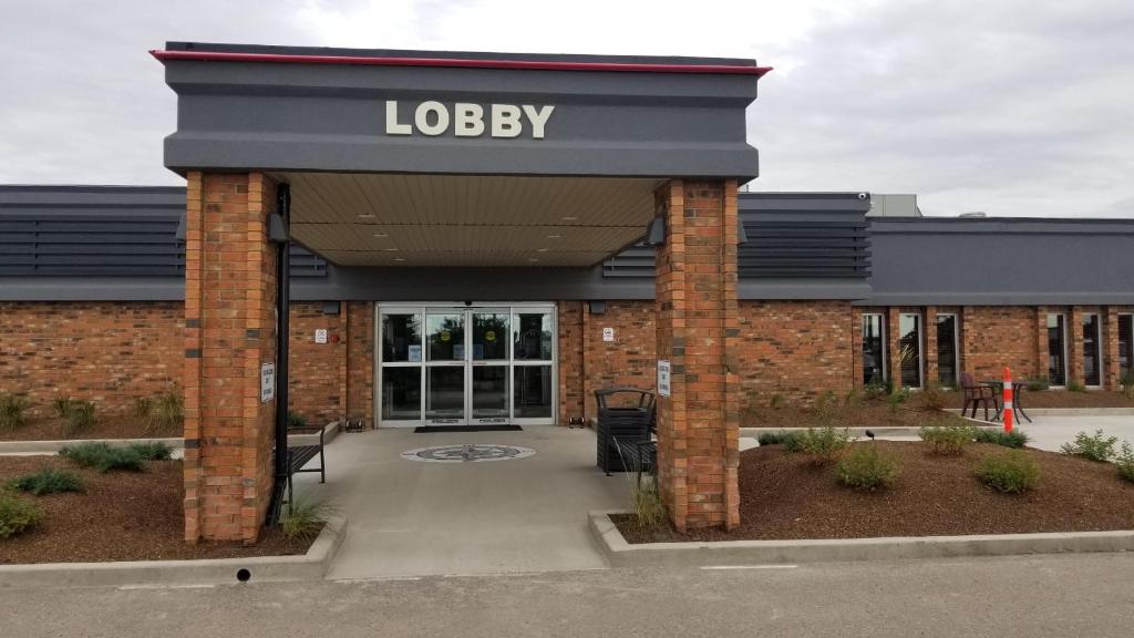 a library with a sign on the front of a building at Neighbourhood Inn Hotels in Bonnyville in Bonnyville