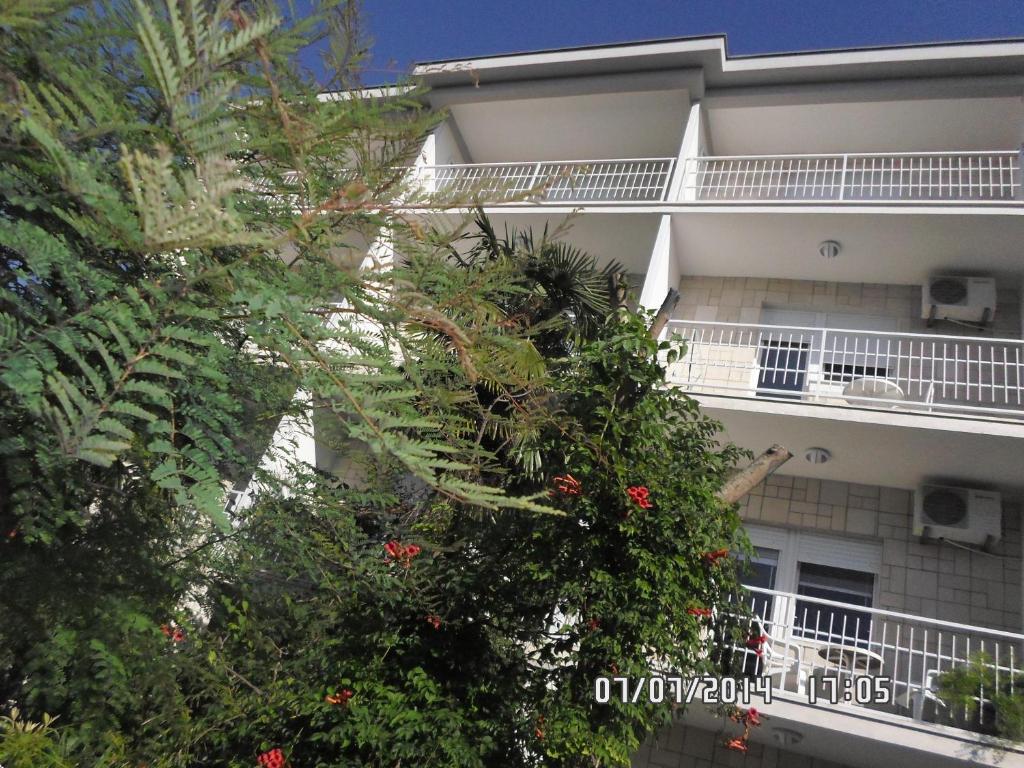 an apartment building with plants on the side of it at House Danica Apartments & Rooms in Sukošan