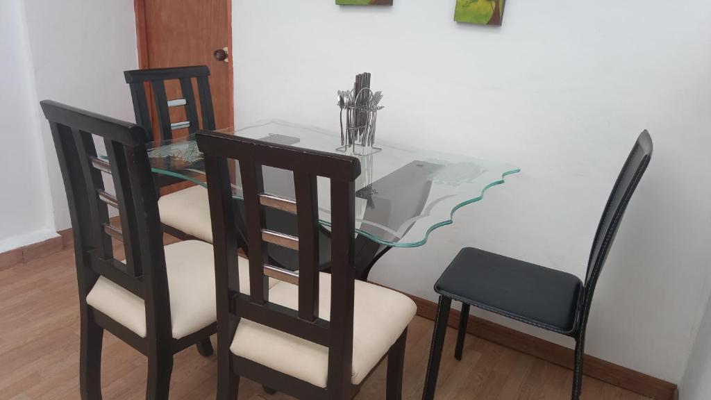a dining room table with two chairs and a glass table at Mi Balconcito in Salento