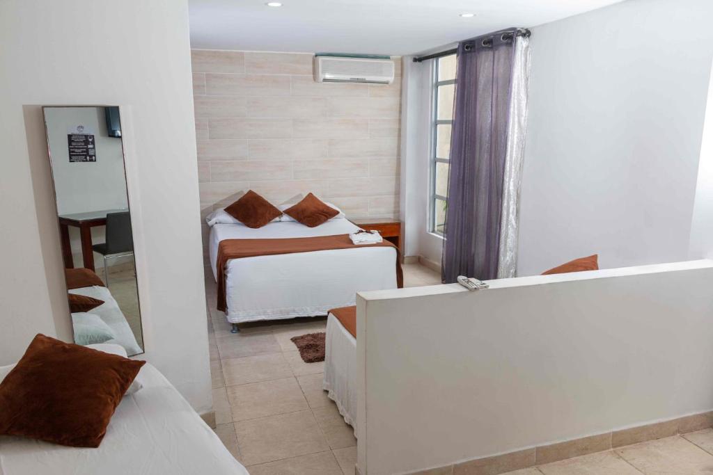 Postel nebo postele na pokoji v ubytování Zuruma Hotel