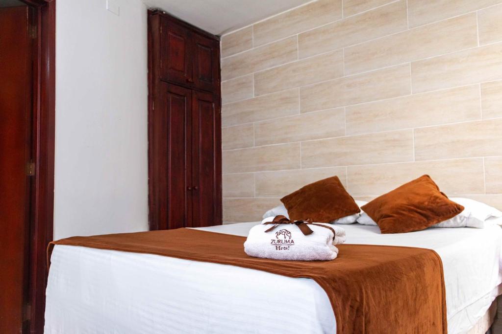 Postel nebo postele na pokoji v ubytování Zuruma Hotel