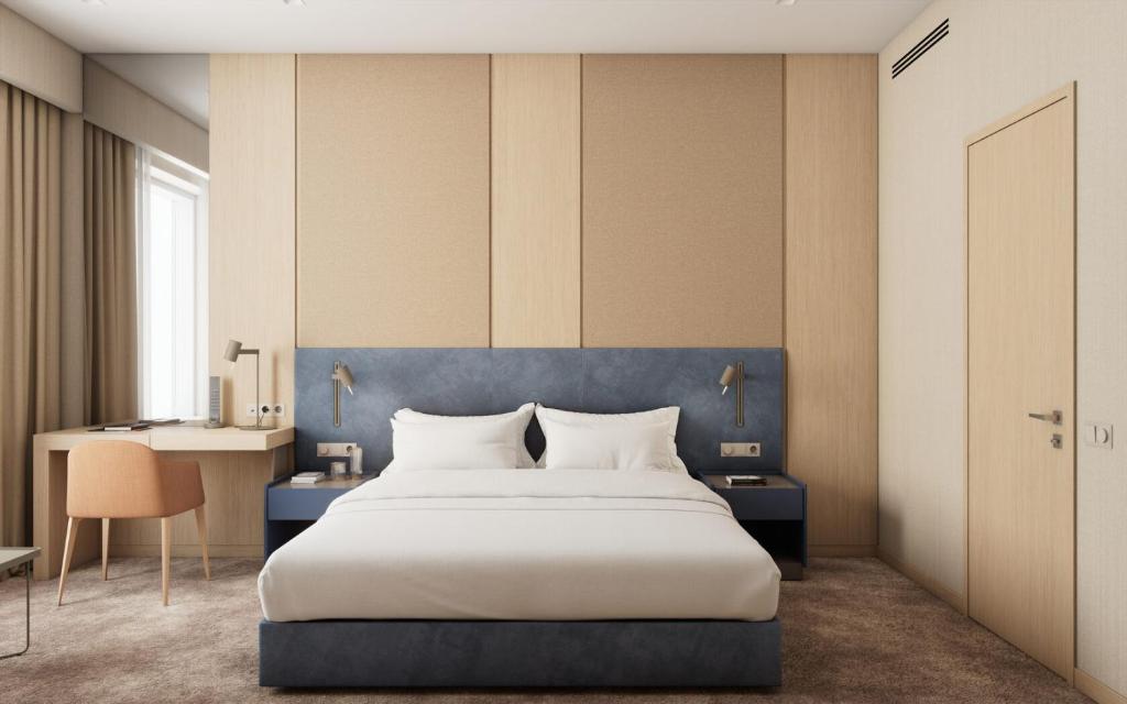 Postel nebo postele na pokoji v ubytování LEGENDA Aero hotel
