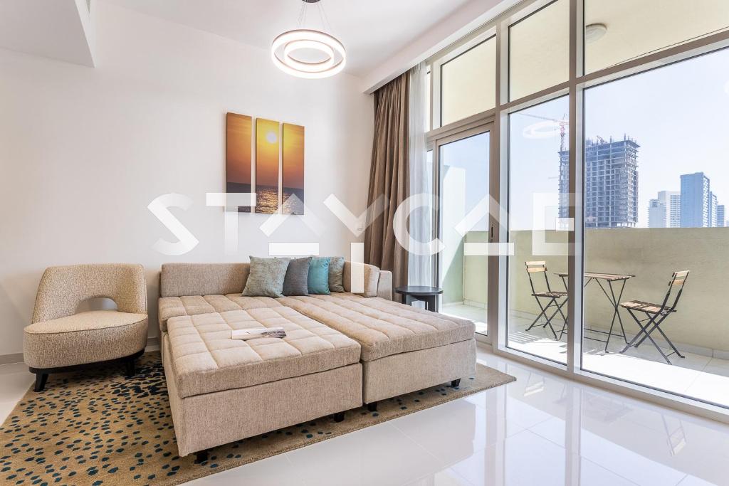 a living room with a couch and a table at Staycae Holiday Homes - Tower 108 in Dubai