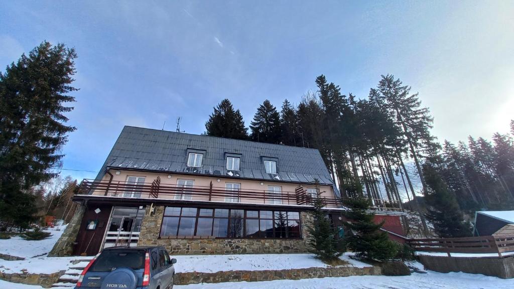 a house with a car parked in front of it at Veghouse - Penzion u pláže in Horní Bečva