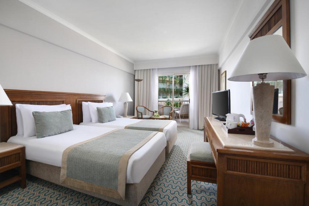 A bed or beds in a room at Iberotel Luxor