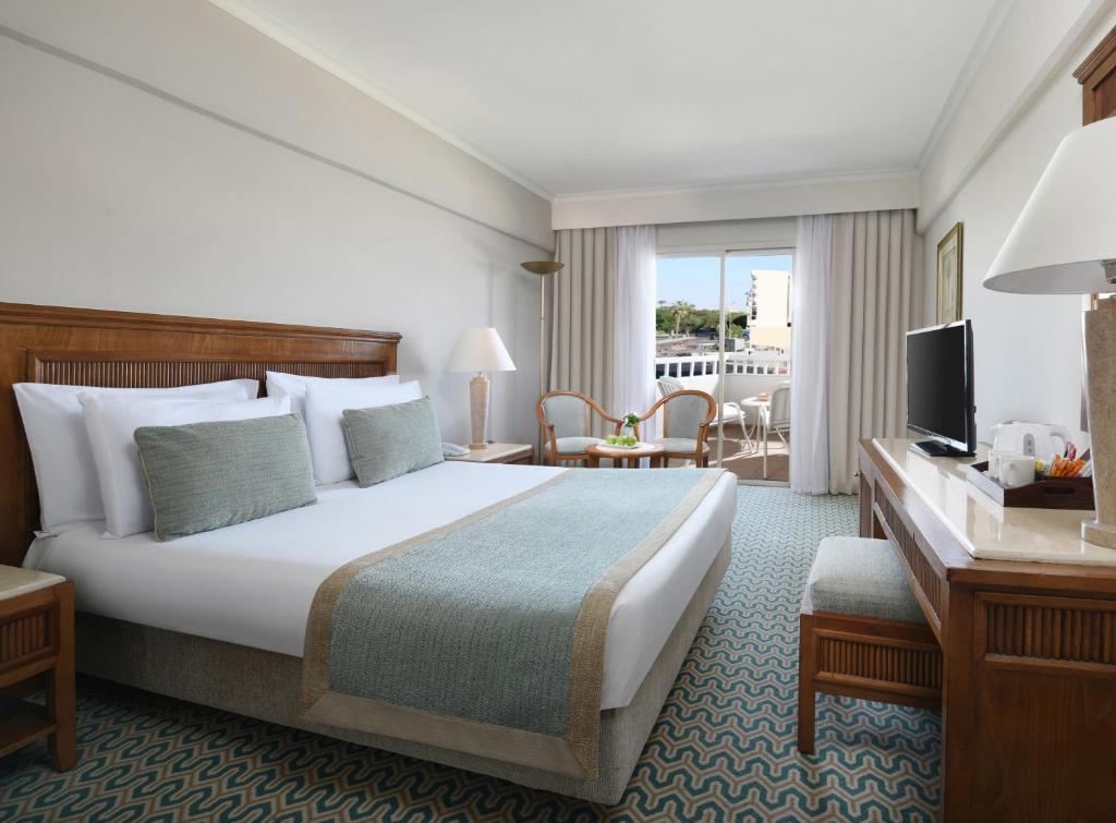 A bed or beds in a room at Iberotel Luxor