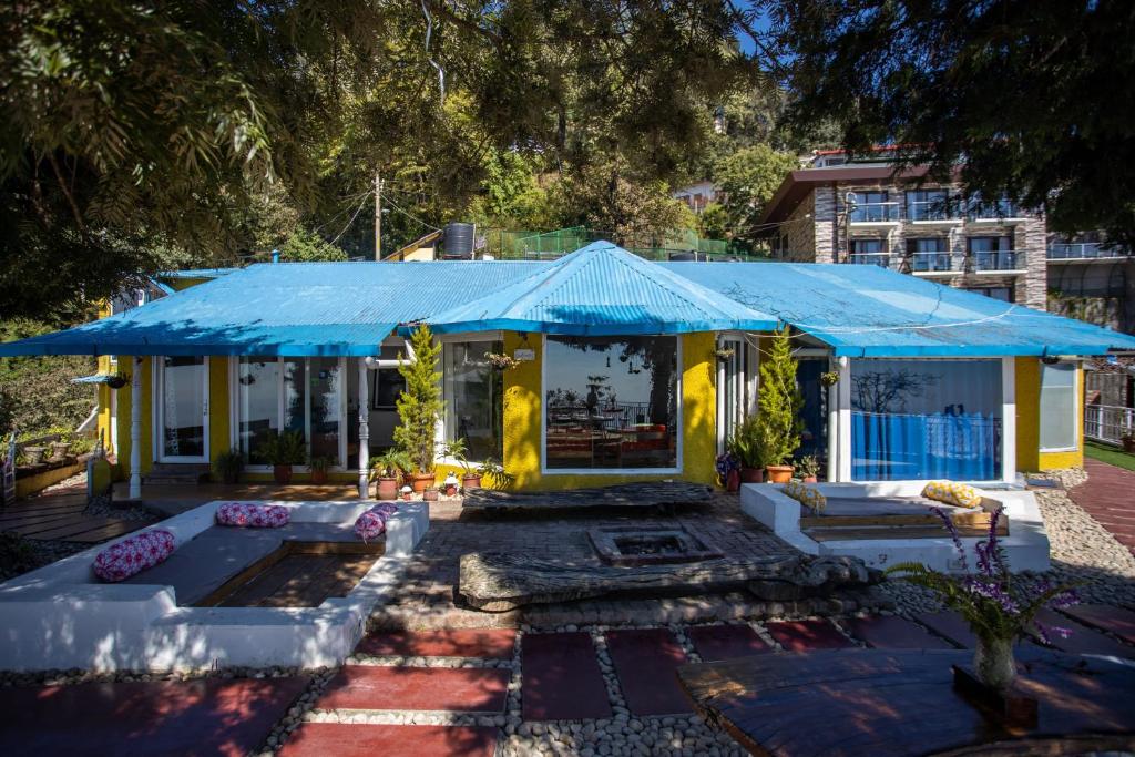 a house with a blue tent in a yard at Seclude Mussoorie in Mussoorie