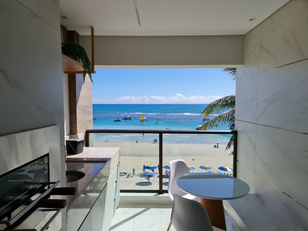 a living room with a view of the beach at Apto Beira-mar vista piscinas naturais in Porto De Galinhas