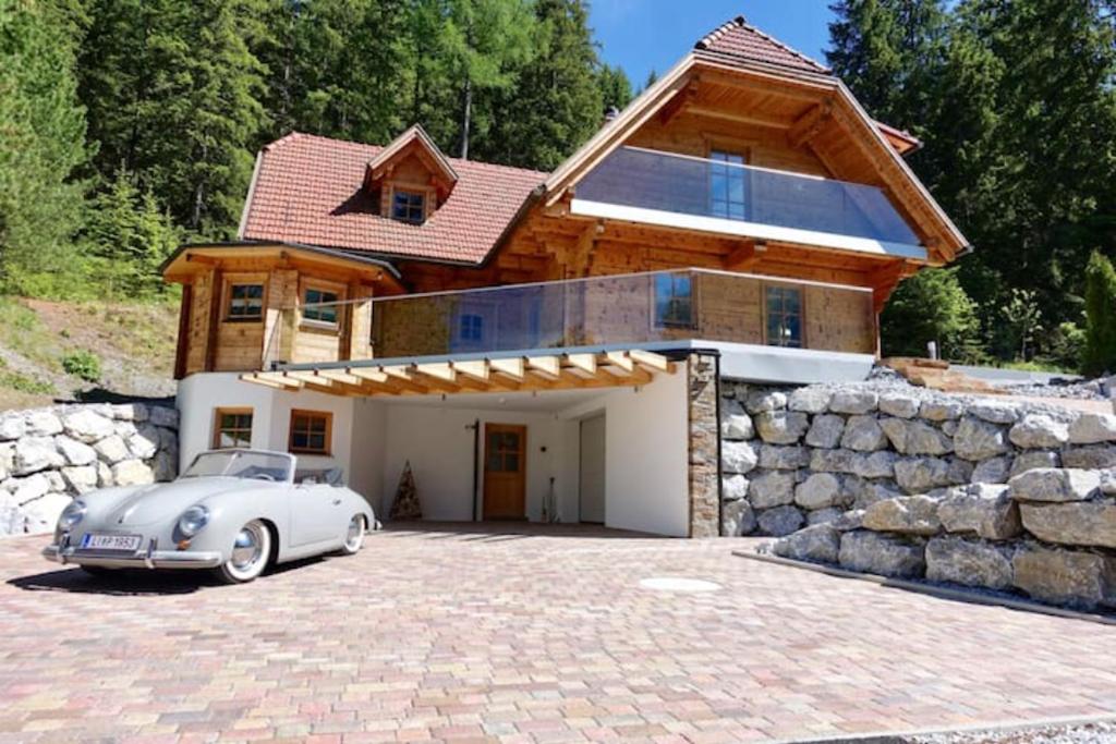 a white car parked in front of a house at Chalet Sodamin Alpin mit Wellness in Hohentauern