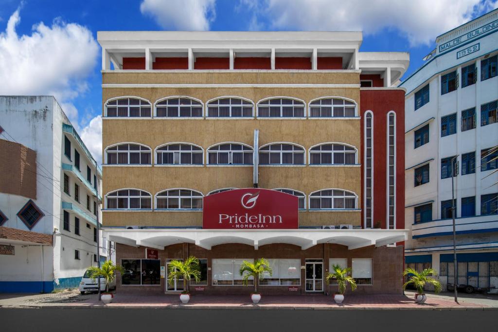 a building with a sign on the front of it at PrideInn Hotel Mombasa City in Mombasa