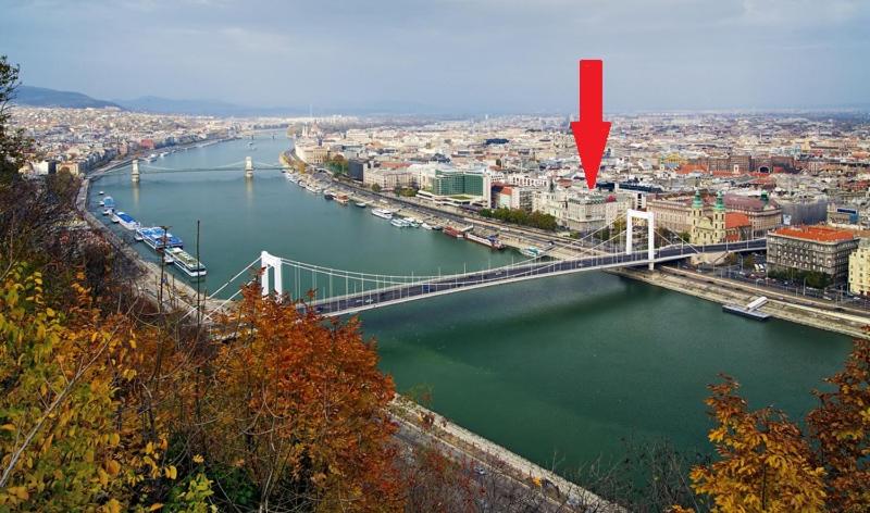 a view of a river with a bridge and a city at Monolit Budapest Center Guesthouse in Budapest