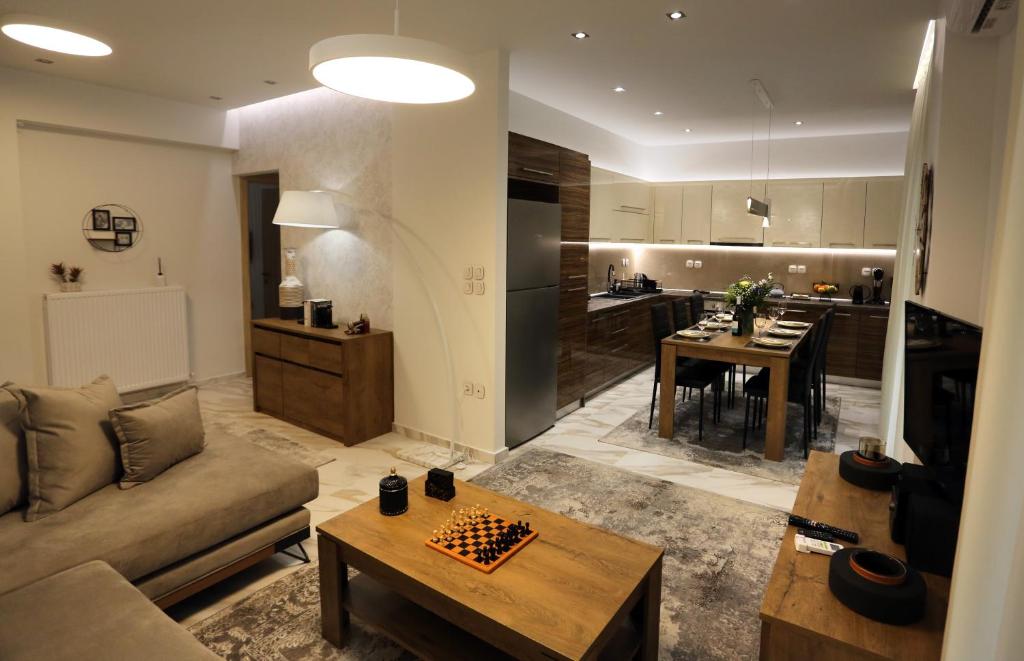 a living room with a couch and a chess board at LA Larissa Luxury Apartments Peneus in Larisa