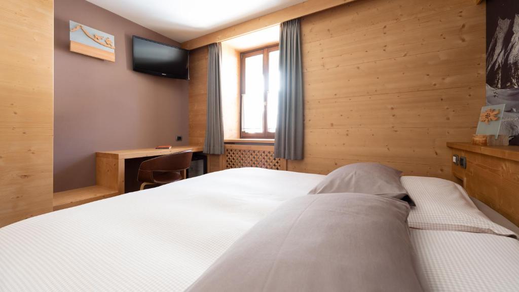 Postel nebo postele na pokoji v ubytování Hotel Compagnoni