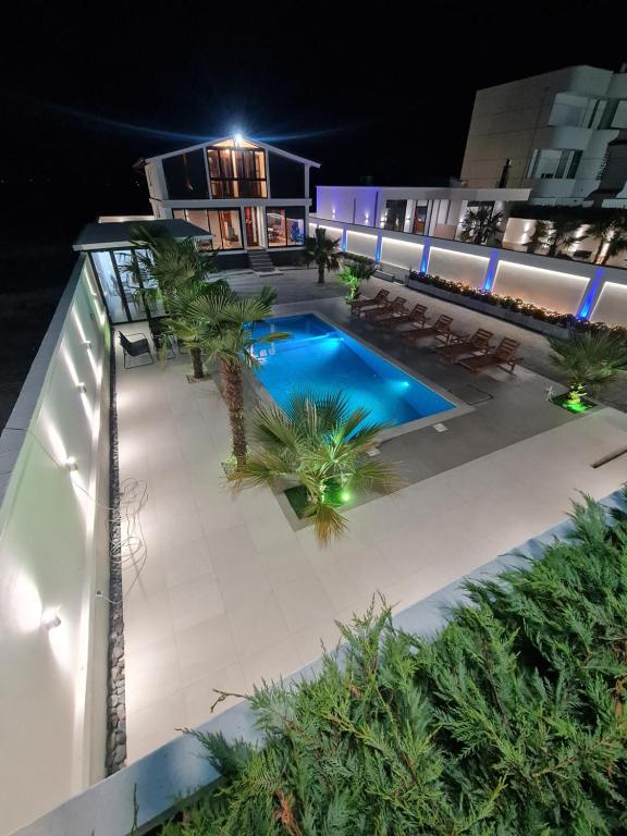 an overhead view of a swimming pool at night at Isea Wood Villa in Rrushkull
