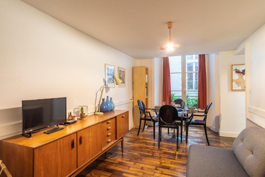 un salon avec une télévision et une salle à manger dans l'établissement Le Parvis-Beau Duplex centre, à Rennes