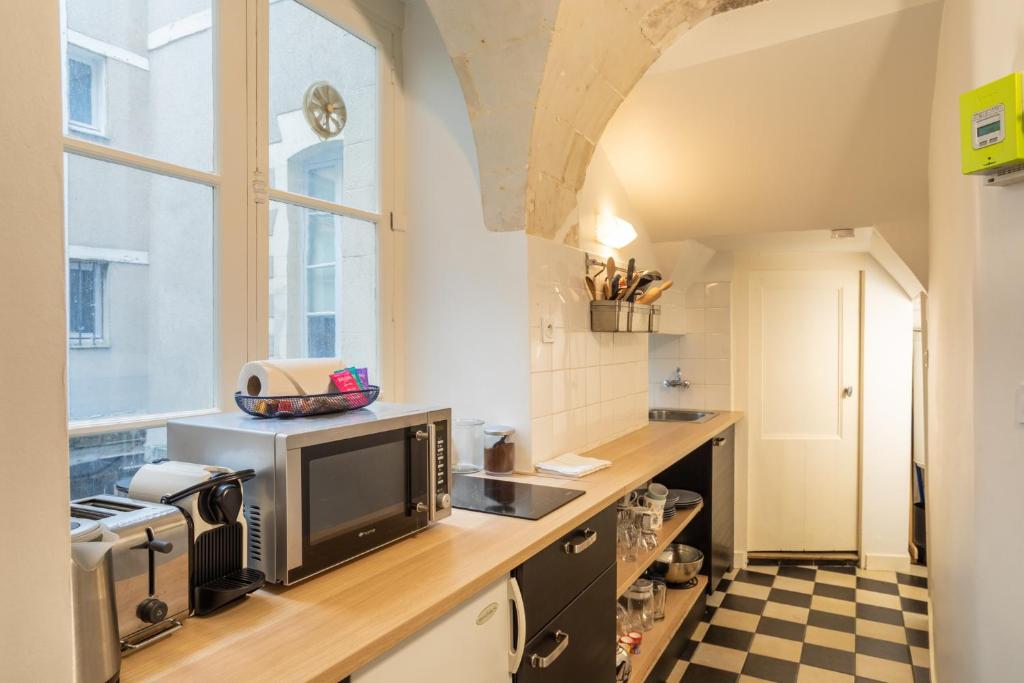 a kitchen with a sink and a counter top at Le Parvis-Beau Duplex centre in Rennes