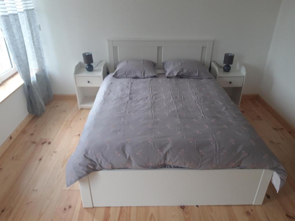 a bedroom with a large bed with two night stands at La Meunière in Montmerrei