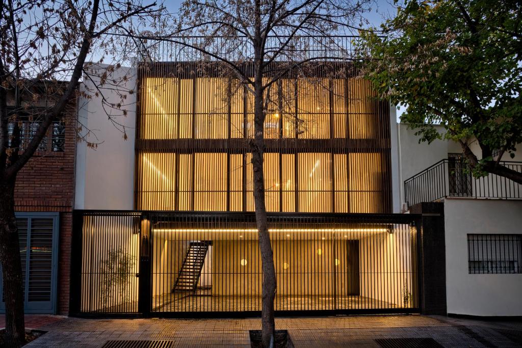 a building with a gate with a staircase in front of it at Escala83 Apartamentos in Mendoza