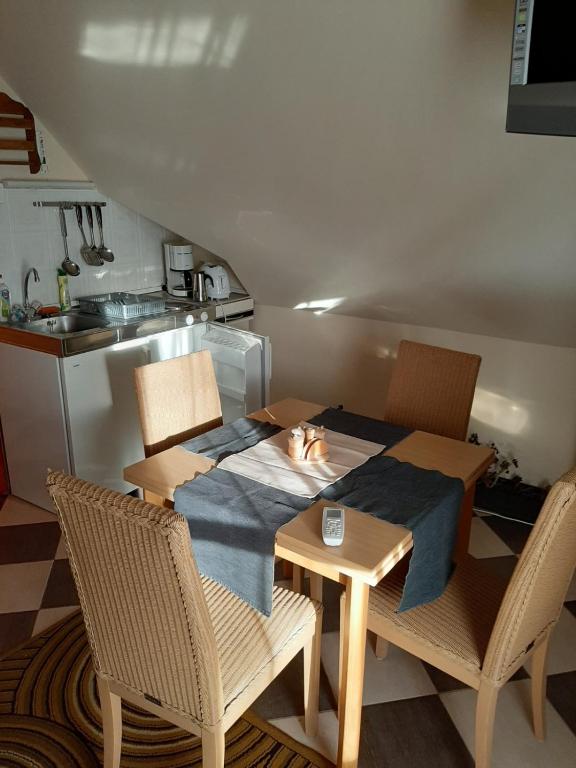 a dining room table with a cat sleeping on the table at Krémer Vendégház in Harkány