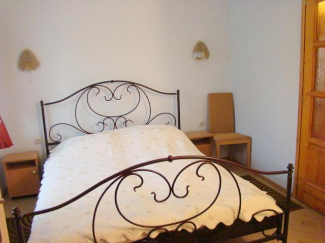 a bedroom with a bed with a metal frame at Krémer Vendégház in Harkány