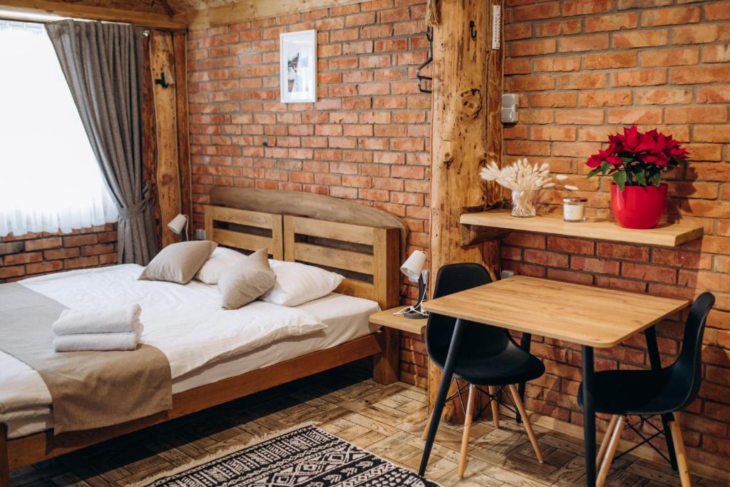 a bedroom with a bed and a table and a desk at Dolyna Mykolaya in Migovo