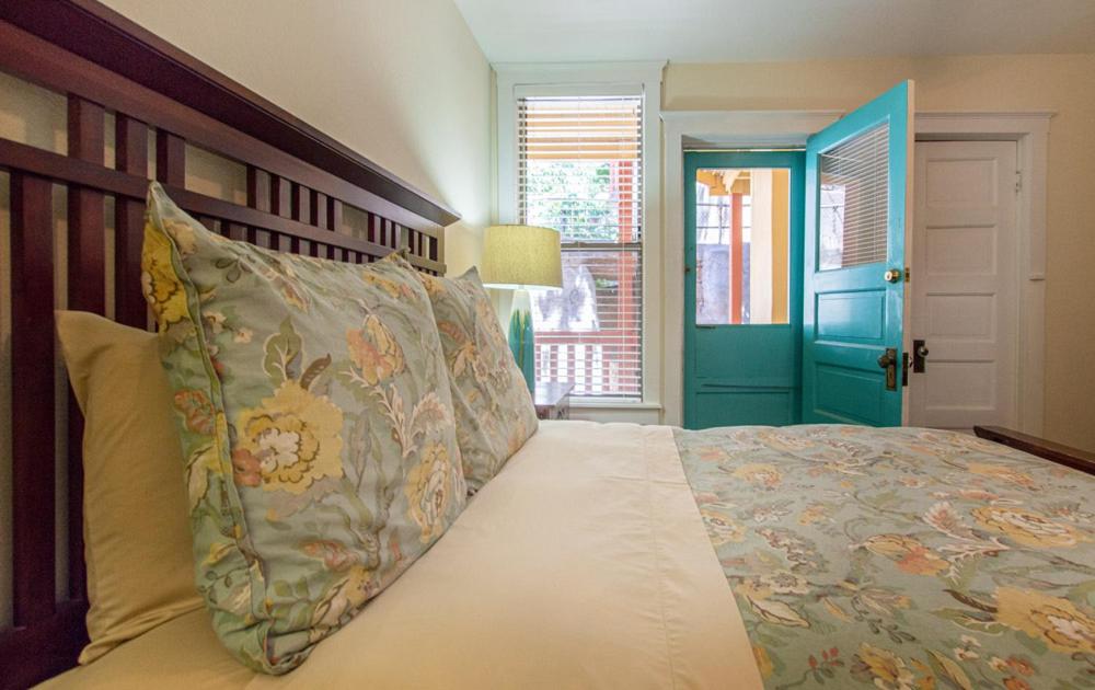 a bedroom with a bed and a blue door at Eldorado Suites Hotel in Bisbee