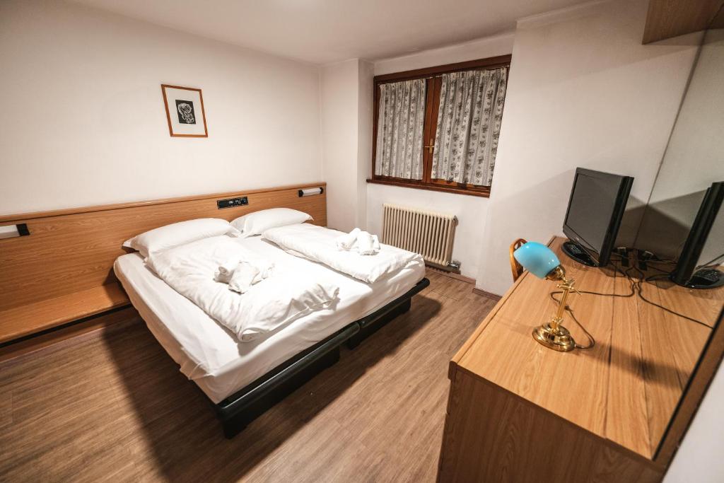 Postel nebo postele na pokoji v ubytování Smart Hotel Renzi