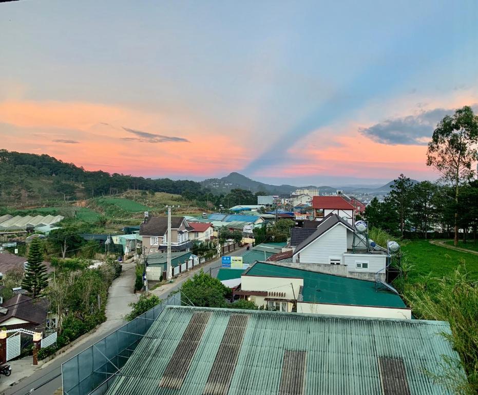 a view of a town with a rainbow in the sky at Villa Délight House “Stay&Chill” in Da Lat